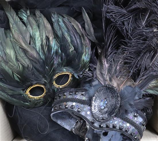 A collection of feather masks, a cape / collar etc.